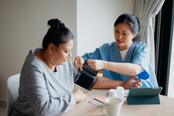 nurse taking patient blood pressure