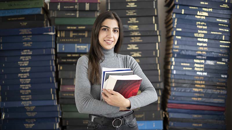 student holding books
